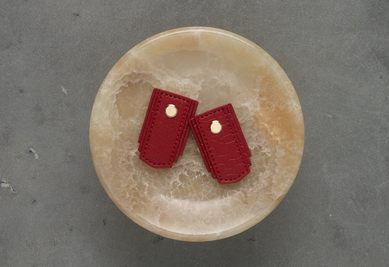 Red leather pull from Sagitine, featuring a sleek design and high-quality craftsmanship