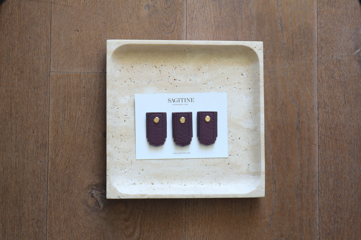 Plum leather pull handle by Sagitine, featuring a sleek and simple design.