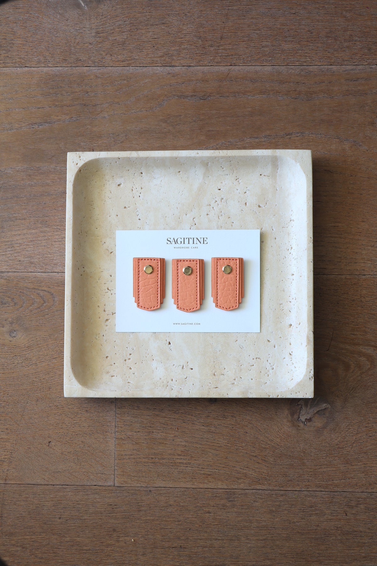 Apricot leather pull handle by Sagitine, featuring a smooth texture and modern design.