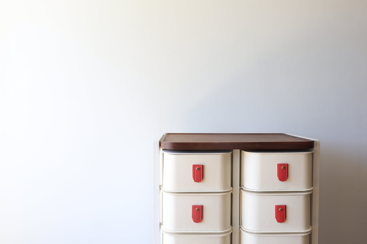 Raspberry leather pull handle by Sagitine, featuring a sleek design and vibrant color