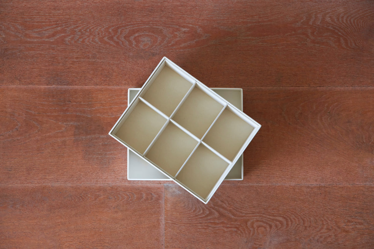 White insert set with compartments, designed for organizing belts, by SAGITINE.