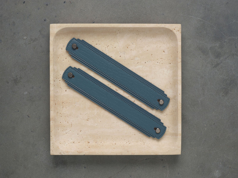 Blue leather handle by Sagitine with a sleek design for easy gripping